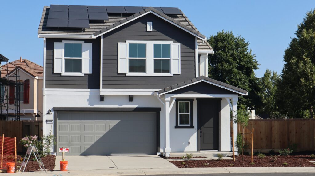 Newly constructed suburban home in Elk Grove, California, featuring solar panels and a stylish exterior.